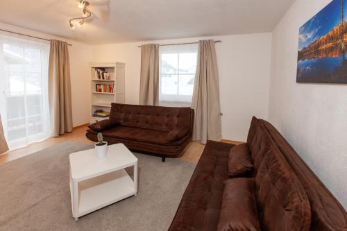 a living room with a couch and a table at Apart Plangger in Nauders
