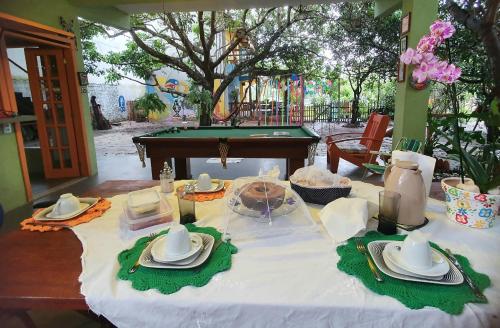 Quintal da Espera - Praia de Itacimirim في كامساري: a table with a table cloth and a pool table sidx six