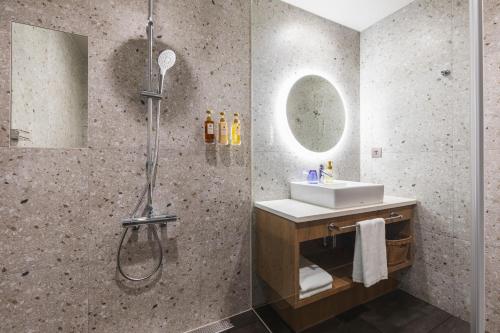 a bathroom with a shower and a sink at Sotetsu Grand Fresa Taipei Ximen in Taipei