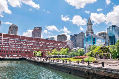 a building next to a river in a city at Boston Marriott Long Wharf in Boston