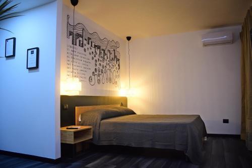 a bedroom with a bed and a sign on the wall at La Dimora Del RE in Salerno