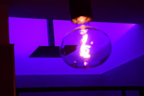 a vase with a purple light in a dark room at La Dimora Del RE in Salerno