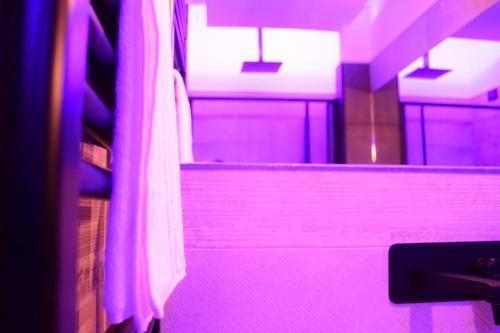 a bathroom with purple lighting and a stair case at La Dimora Del RE in Salerno