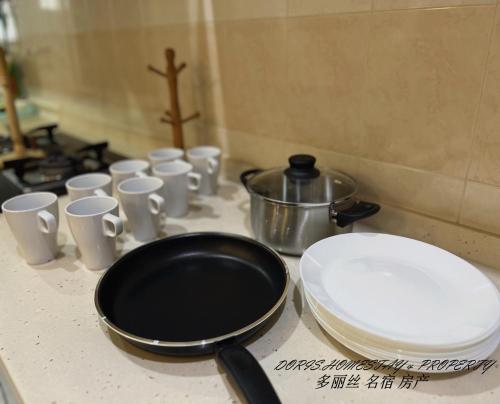大山腳的住宿－2 Storey House Bayu Mutiara @ Bukit Mertajam，配有煎锅和白杯的台面