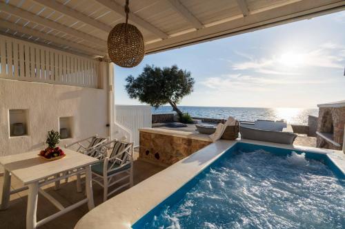 a villa with a swimming pool on the beach at Aegean Melody Suites & Villas in Vlychada
