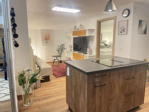 a kitchen with a island in the middle of a room at Komfort-Apartments Waidring in Waidring