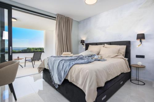 a bedroom with a large bed and a large window at Deluxe villa with heated pool, whirpool, sea view, beautiful beach IV - by Traveler tourist agency Krk ID 2403 in Krk