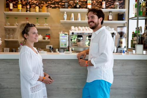 a man and a woman standing next to a counter at Don Antonio Glamping Village in Giulianova