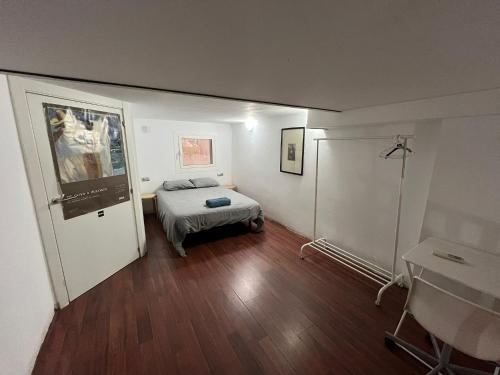 a bedroom with a bed and a table in it at Centrally Apartment in the Heart of Raval in Barcelona