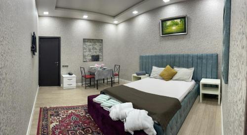 a bedroom with a bed and a table in a room at NRS Hotel in Baku