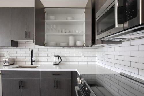 a kitchen with a sink and a counter top at Kendall Square studio w gym wd rooftop BOS-918 in Boston