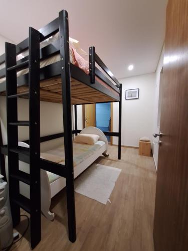 a bedroom with two bunk beds in a room at cerca do casal in Santo Tirso