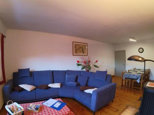 a living room with a blue couch and a table at Soldeu Paradis Soldeu in Soldeu