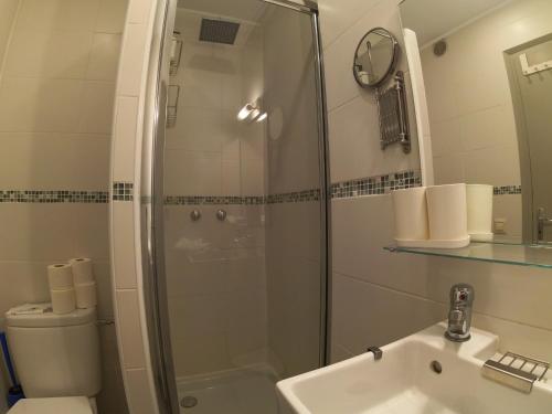 a bathroom with a shower and a sink and a toilet at Soldeu Paradis Soldeu in Soldeu