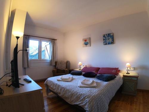 a bedroom with a bed with two towels on it at Soldeu Paradis Soldeu in Soldeu
