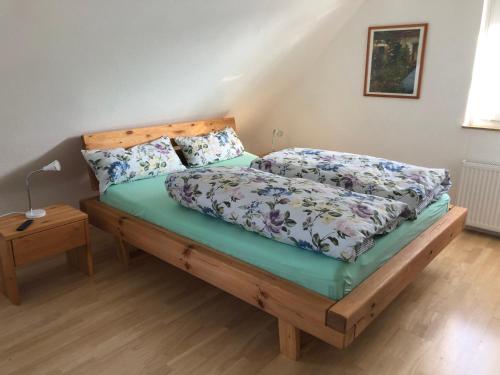 a bedroom with a bed with a wooden headboard at Grüne Oase in Bad Nenndorf