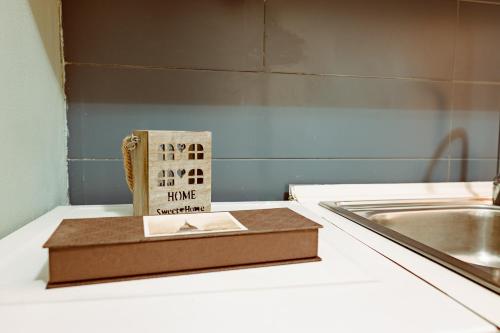 a book sitting on top of a counter next to a sink at Loft Pozzo Strada in Turin