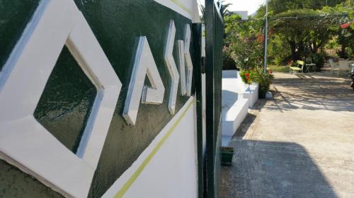 a wall with a sign on the side of a building at Oasis in Kamarai