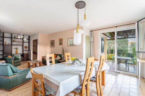 une salle à manger et un salon avec une table et des chaises dans l'établissement Céleste - Maison 3 chambres et jardin, au Pradet