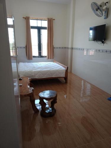 Zimmer mit 2 Betten und einem Hocker in der Unterkunft Tam Ky XO Hotel in Tam Kỳ