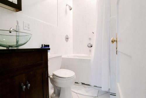 a bathroom with a toilet and a sink and a tub at Missions Dolores 1br nr dining cafes shops SFO-1621 in San Francisco