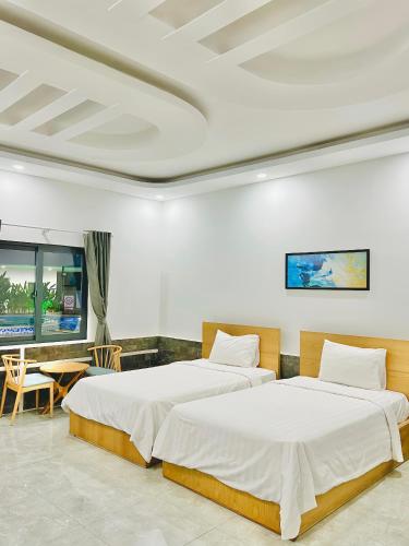 Postel nebo postele na pokoji v ubytování Khách sạn Khang Điền 2