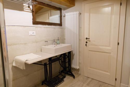 ein Bad mit einem Waschbecken und einem Spiegel in der Unterkunft Casa Pini Rio_A in Riolunato
