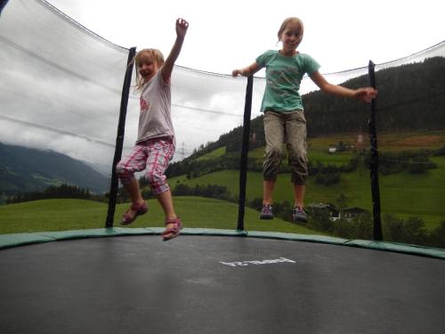 two young girls jumping on a trampoline at Vordergugg in Mittersill