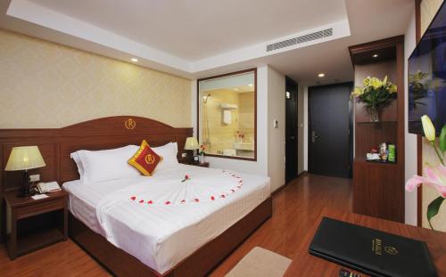 a bedroom with a large bed in a room at Regalia Nha Trang in Nha Trang