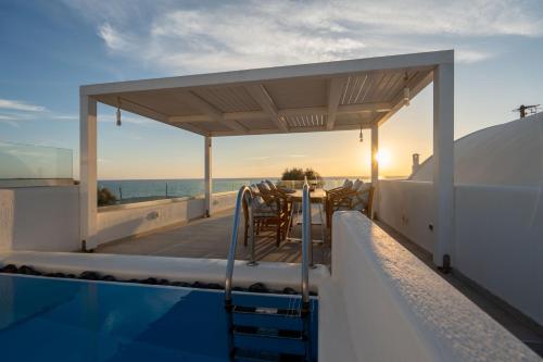 a view from the roof of a house with a swimming pool at Aegean Melody Suites & Villas in Vlychada