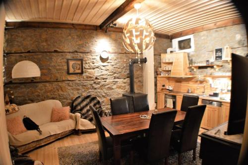 a living room with a wooden table and a couch at EskiZ - Our stone home in Chepelare