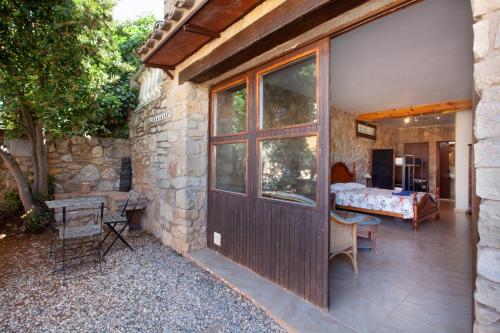 a stone house with a wooden door and a bedroom at Aaccent Montblanc - Prenafeta in Montblanc