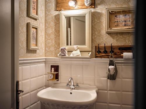 a bathroom with a sink and a mirror at HOTEL StDaniel in Štanjel