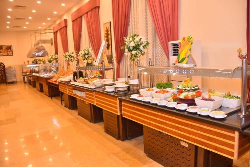a buffet line with a lot of food on at Jewel Sport City and Aqua Park in Cairo