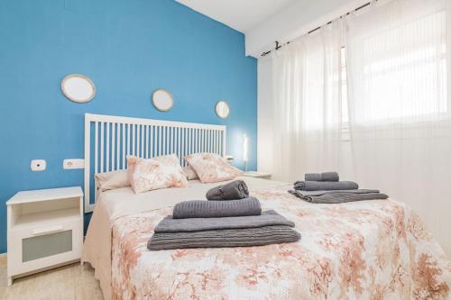 1 dormitorio con 1 cama grande y toallas. en Marina - Delicia al sur en El Altet