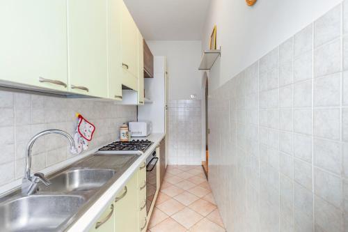 a small kitchen with a sink and a stove at Casa Giancarlo by Rentbeat in Rome