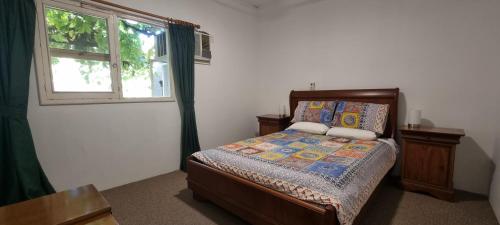 a bedroom with a bed and a window at The Sunday School Cottage on the Heysen Trail in Burra