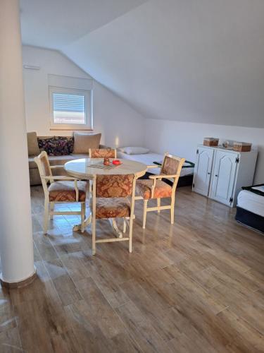 a living room with a table and chairs and a couch at Expo Airport otel in Surčin