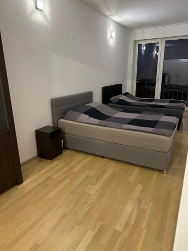a bedroom with a bed and a wooden floor at Geräumiges modernes Apartment 1-6 Personen in Imst