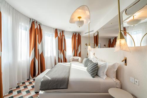 a bedroom with a white bed and a couch at Vincci Capitol in Madrid