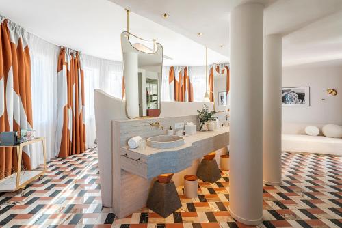 a bathroom with a sink and a large mirror at Vincci Capitol in Madrid