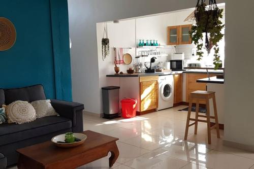 a living room with a couch and a kitchen at La belle rencontre in Mamoudzou