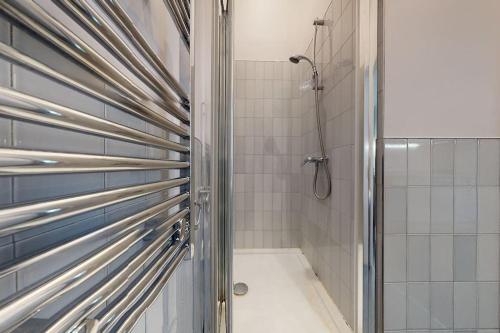 a shower with a glass door in a bathroom at Small studio in Notting Hill in London