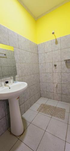 a bathroom with a sink and a shower at Quanam Woods Hotel in Lodwar
