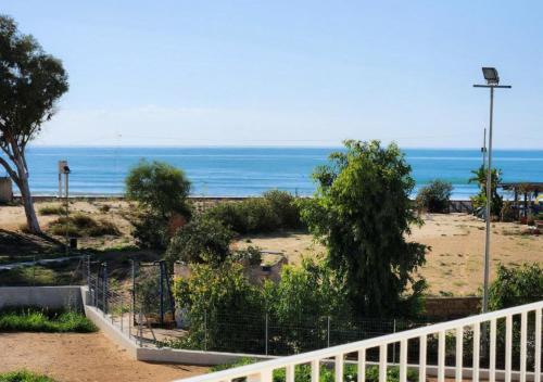 a view of a beach with the ocean in the background at Keys of Sicily - Residence "Sabbia" sul mare in Marina di Modica