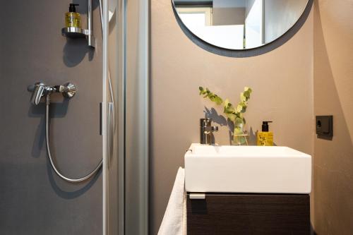 a bathroom with a sink and a mirror at Goldenstern Townhouse in Bolzano