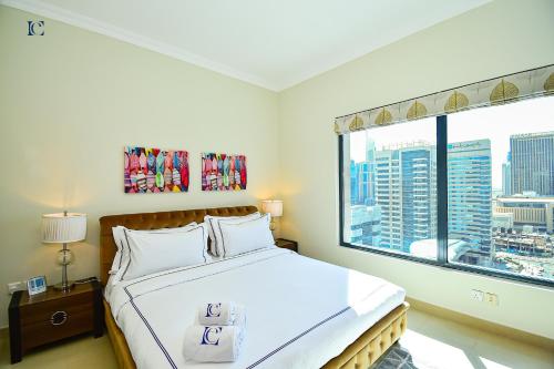 a bedroom with a bed and a large window at Budget 1BR Apt in Marina - Near Tram & Metro -Time in Dubai