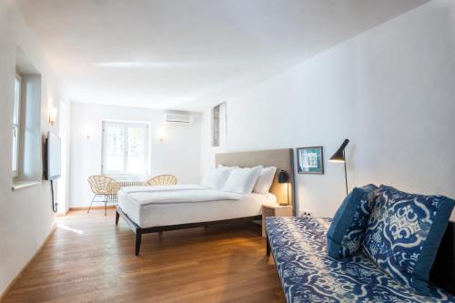 a living room with a bed and a couch at Goldenstern Townhouse in Bolzano