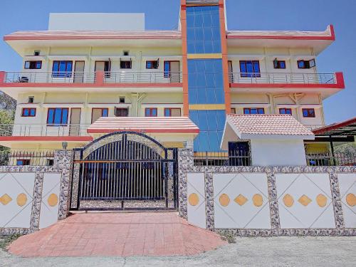 a large building with a gate in front of it at HOME 78802 Balaji Bhawan Jhajra in Dehradun
