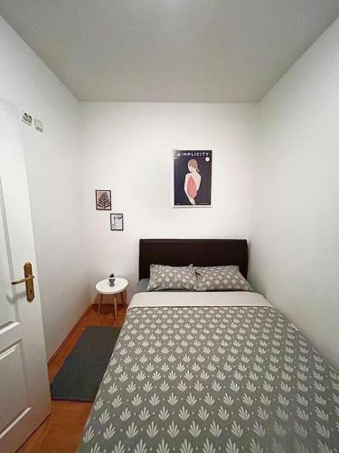 a bedroom with a large bed in a room at Cozy, charming one bedroom apt in Podgorica